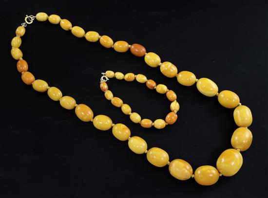 A single strand graduated oval amber bead necklace and similar bracelet, necklace 58cm.